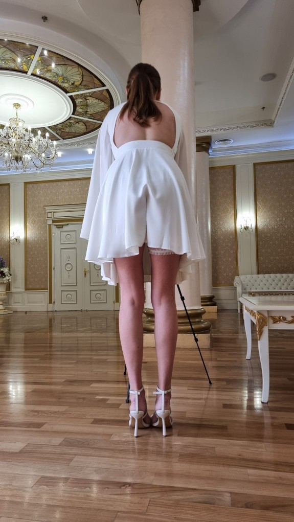 The best angle of long legs under a white dress.