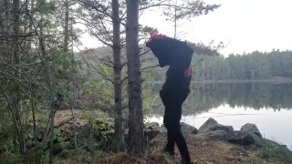 Fursuiter taking a piss against a tree