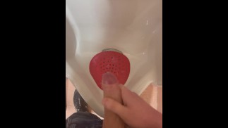 Jerking off into public urinal