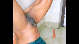 Der kleinste Schwanz aller Transen versucht auf den eigenen Mund zu pissen, indem sie den Penis hinken