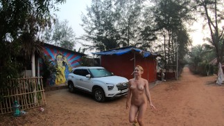 Nude girl walking around the campsite