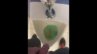 Taking a piss at a urinal